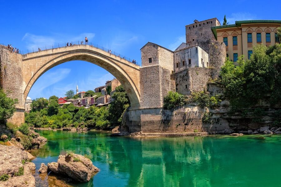 The rebuilt Old Bridge arching over the green Neretva at Mostar